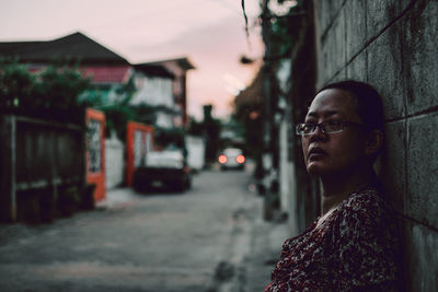 Portrait of woman looking away in city