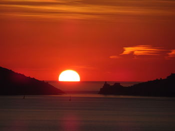 Scenic view of sea against romantic sky at sunset