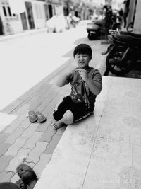 High angle view of boy sitting on floor