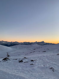 Scenic view of snow covered mountains against clear sky