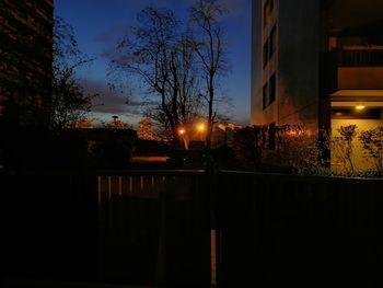 Illuminated buildings against sky at night