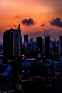 Silhouette buildings against sky during sunset