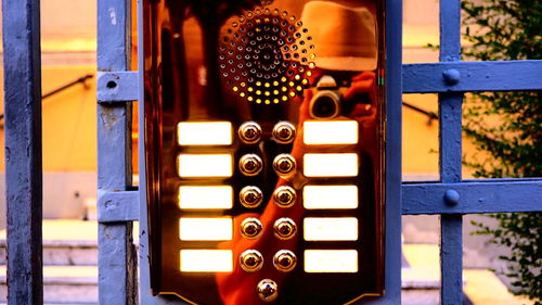 Close-up of intercom on blue fence