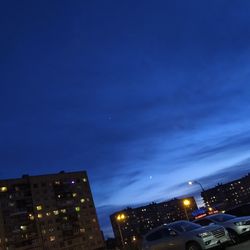 Illuminated buildings against sky at night