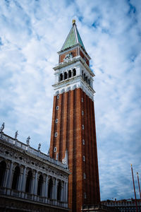 Low angle view of tower against cloudy sky