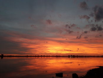 Scenic view of lake against orange sky