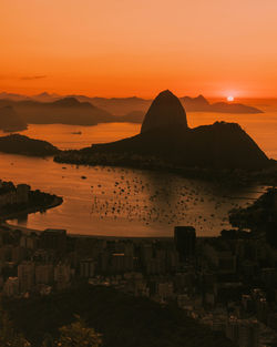 Scenic view of sea against orange sky