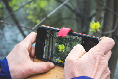 Close-up of hand holding mobile phone