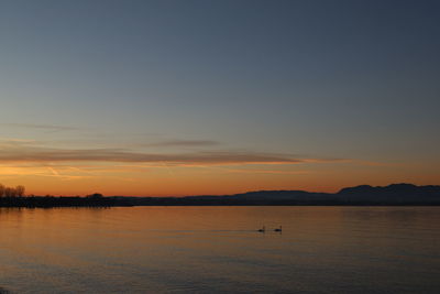 Scenic view of lake against sky during sunset