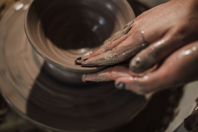 Close-up of artist making pot at workshop