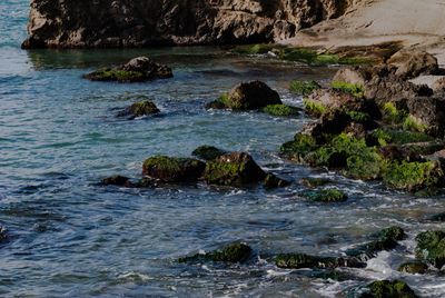 Scenic view of river flowing through rocks