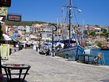 Boats in harbor against buildings in city