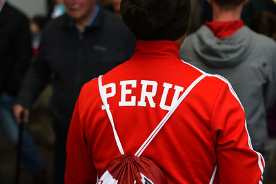 Rear view of man wearing red t-shirt