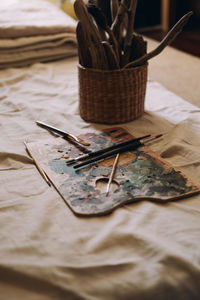 Palette with paints on a white sheet. brushes and paints