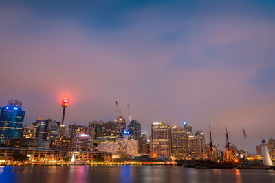 Illuminated buildings against sky at night