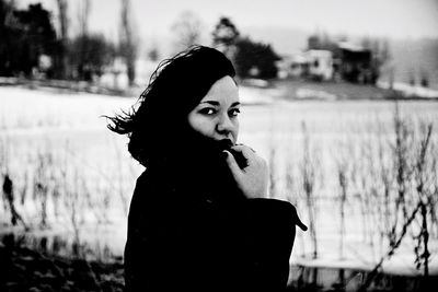 Portrait of young woman smoking outdoors