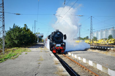 Train on railroad track against sky