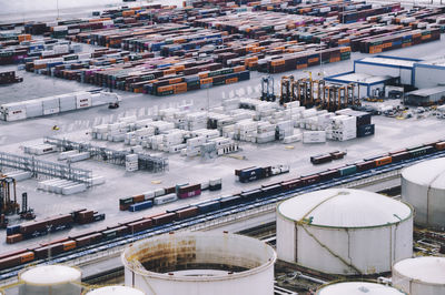 High angle view of illuminated commercial dock by buildings