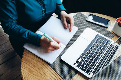 High angle view of man using laptop on table