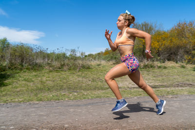 Full length of woman running on road
