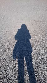 Shadow of man standing on sand