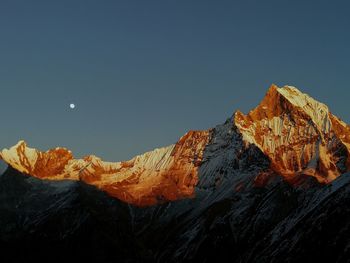 Scenic view of snowcapped mountains against clear sky