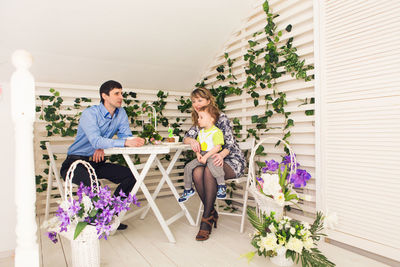 Couple sitting on potted plant