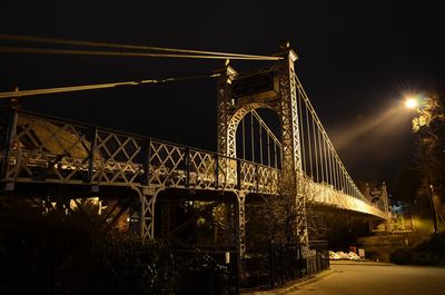 Low angle view of bridge over river at night