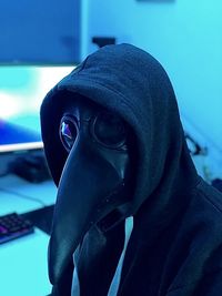 Close-up portrait of man wearing mask