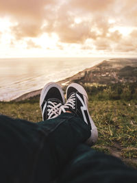 Low section of man wearing shoes