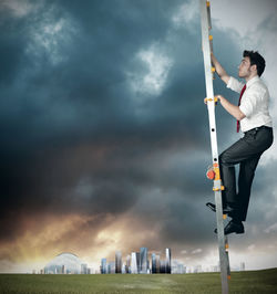 Low angle view of man standing against sky