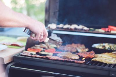 Man preparing food on barbecue grill