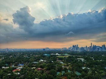 Aerial view of buildings in city during sunset