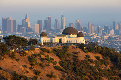 Grifith observatory with the los angeles skyline in the distance at sunset