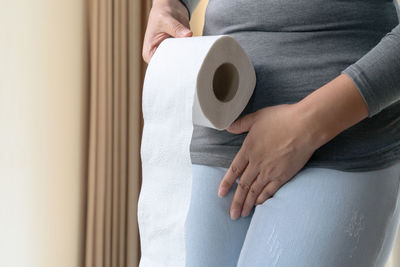 Midsection of woman holding coffee cup