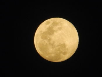 Low angle view of moon against clear sky at night