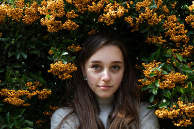 Portrait of woman with red flowers