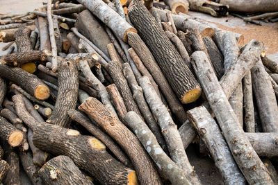 Wood arranged in layers, pile of wood logs ready for industry.