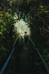 Woman walking on stairs in forest