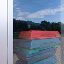 Stack of multi colored glass window against sky