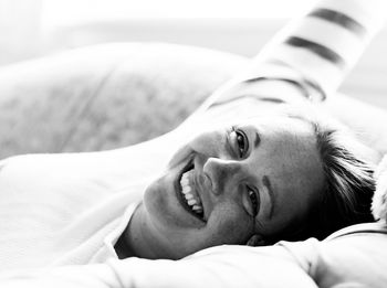 Portrait of woman lying on bed