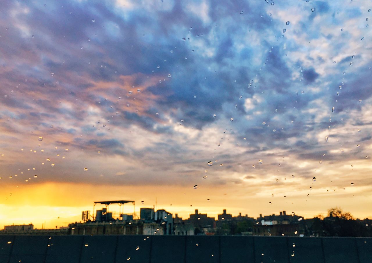 sunset, sky, building exterior, architecture, cloud - sky, built structure, silhouette, city, cloud, cloudy, orange color, weather, dusk, cityscape, dramatic sky, nature, residential structure, house, no people, moody sky