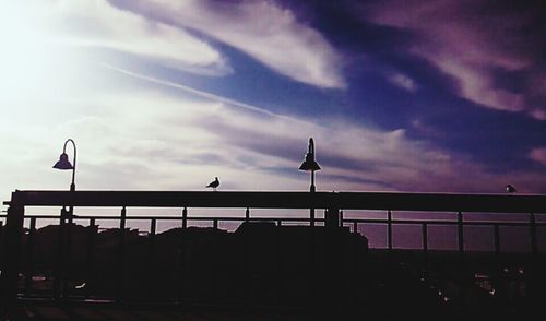 Low angle view of street light against cloudy sky