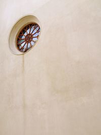 Low angle view of clock on wall