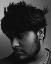 Close-up portrait of young man against wall