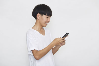 Man using smart phone against white background