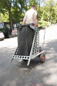 Rear view of man skateboarding on road