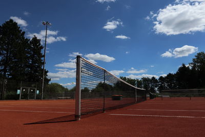 Scenic view of tennis field against sky