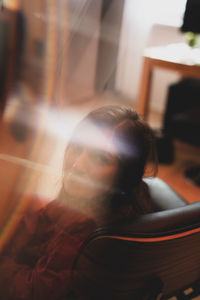 Portrait of young woman at home