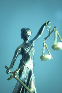 Close-up of lady justice against turquoise background